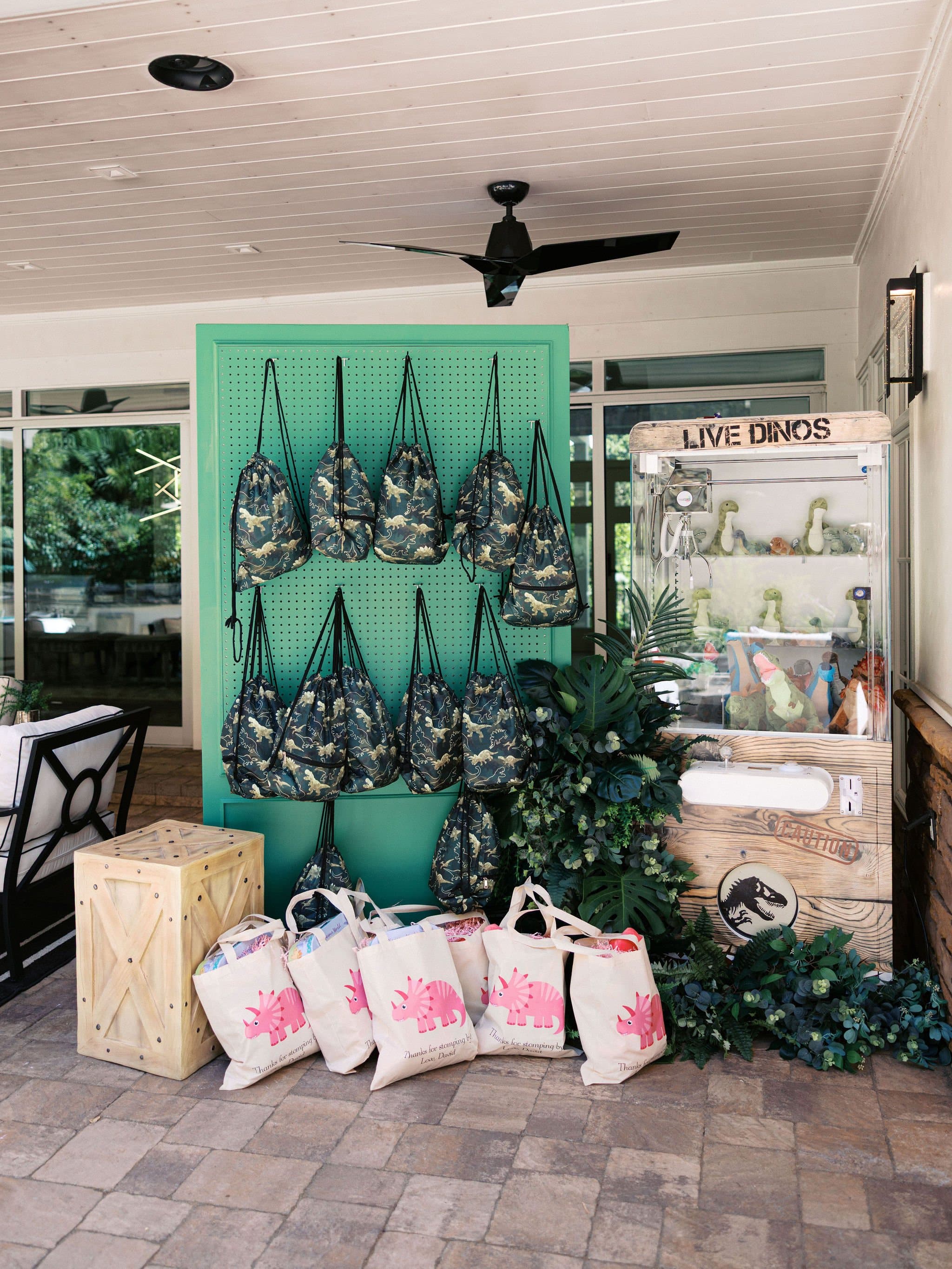 Party favour bags on a green pegboard