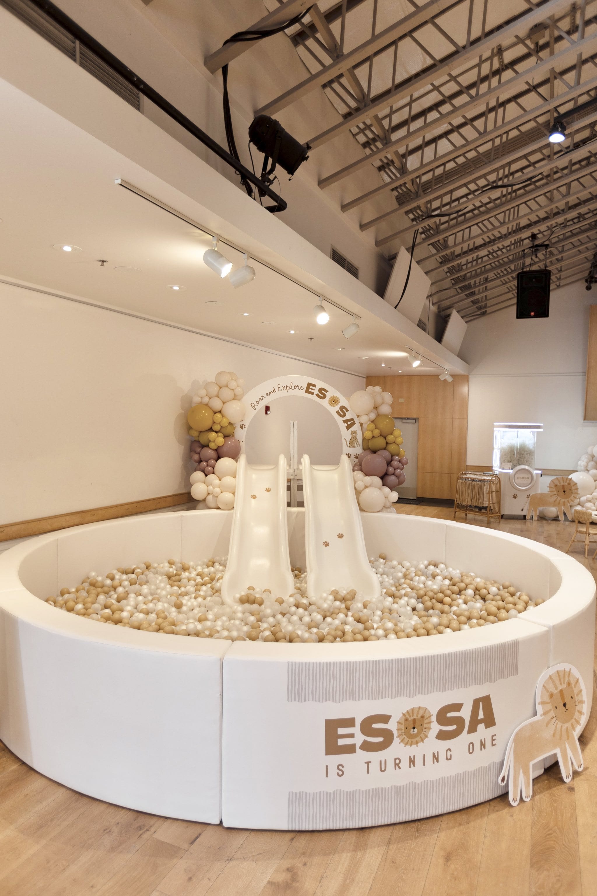 An indoor ball pit with a double slide at a party venue